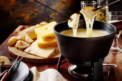 black fondue bowl, bread, and cheese