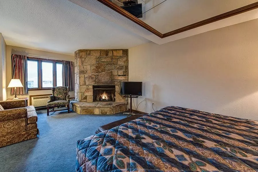 A bedroom at Sidney James Mountain Lodge with a fireplace.