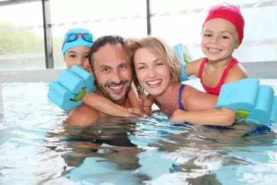 A family enjoying an indoor pool.
