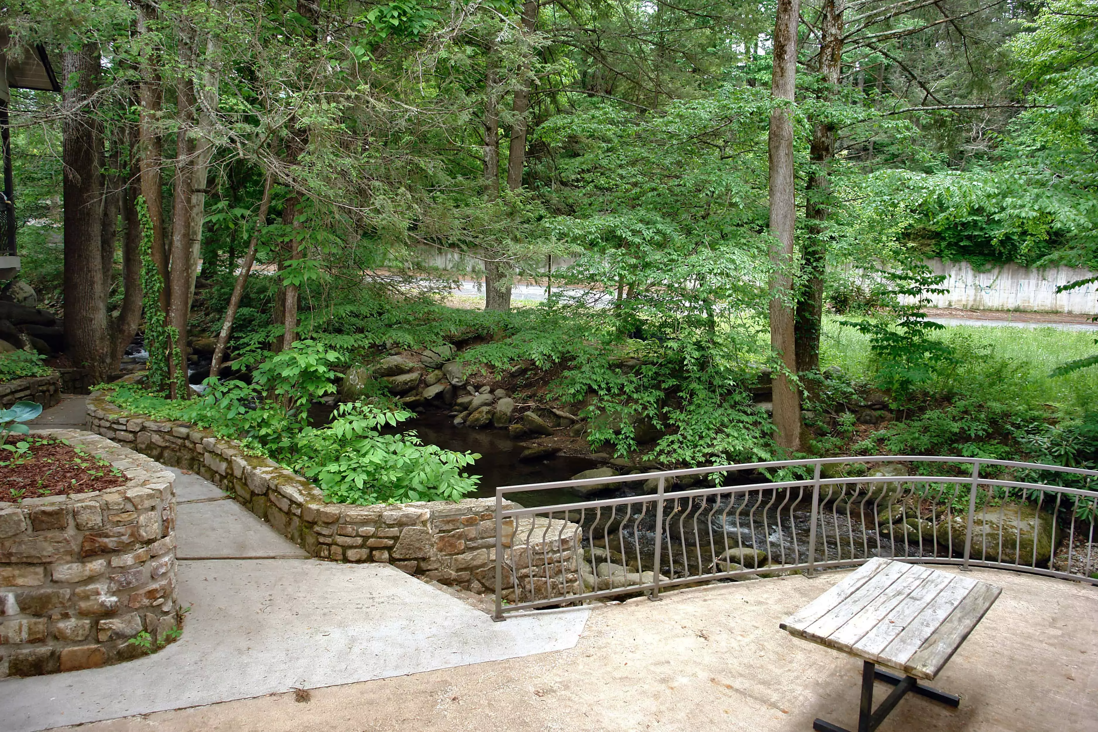 outdoor picnic area next to mountain stream