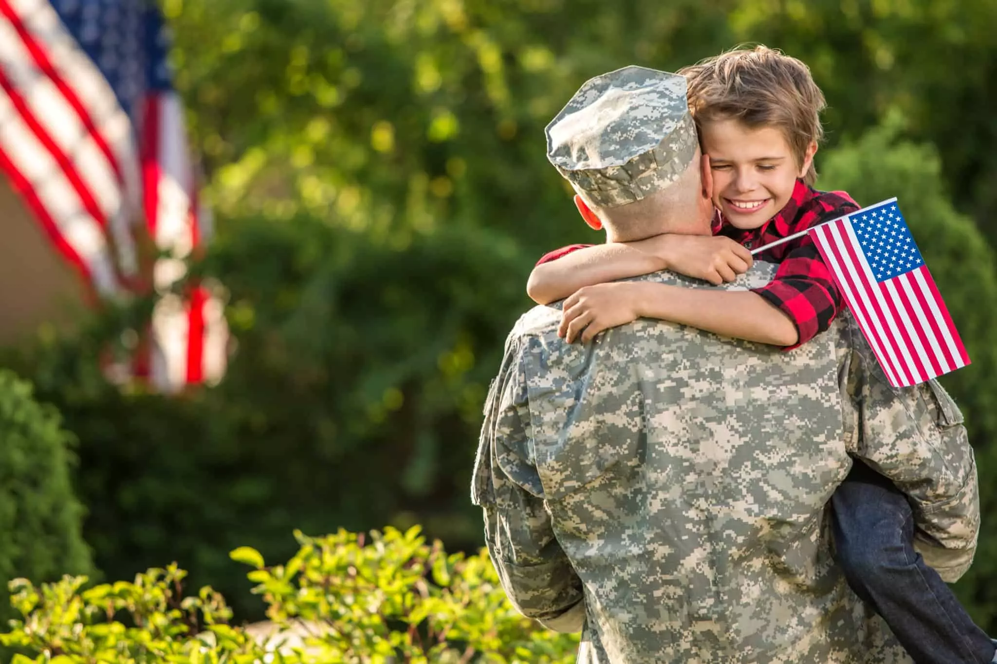 military father hugging son