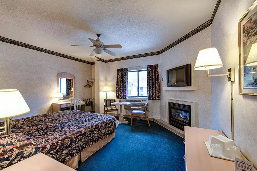 Inside of Club Level King Room with King bed and fireplace
