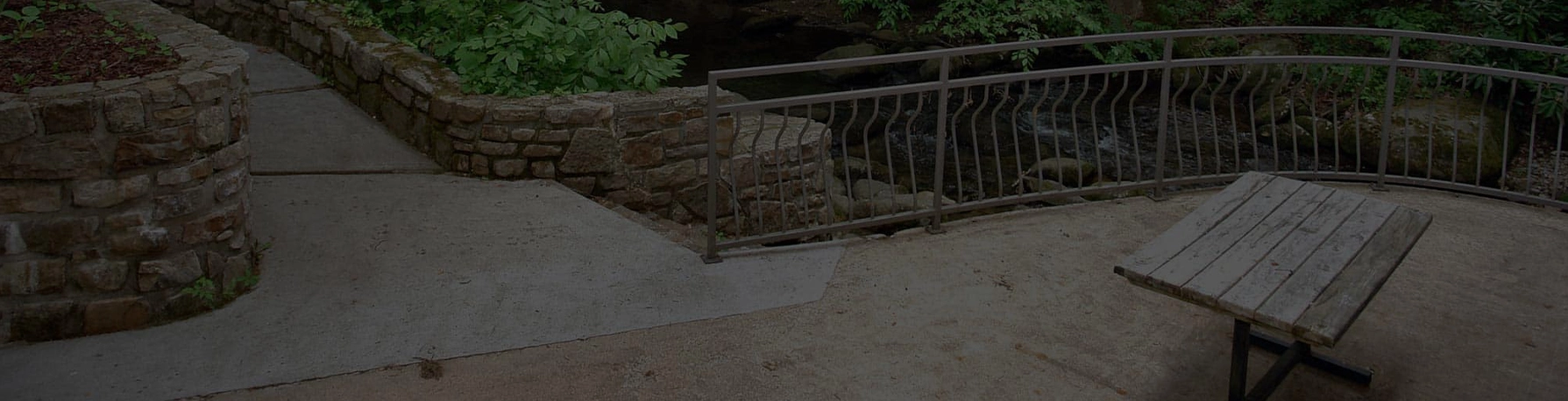 outdoor picnic area next to mountain stream