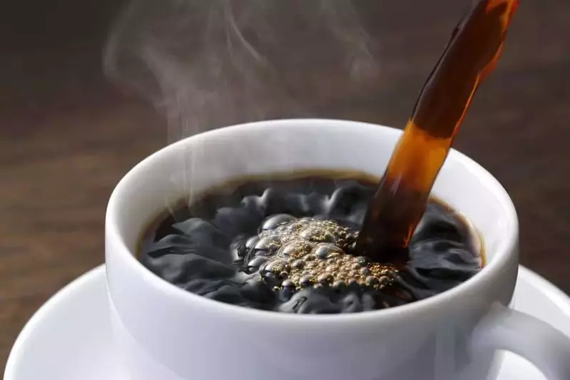 coffee being poured in a cup