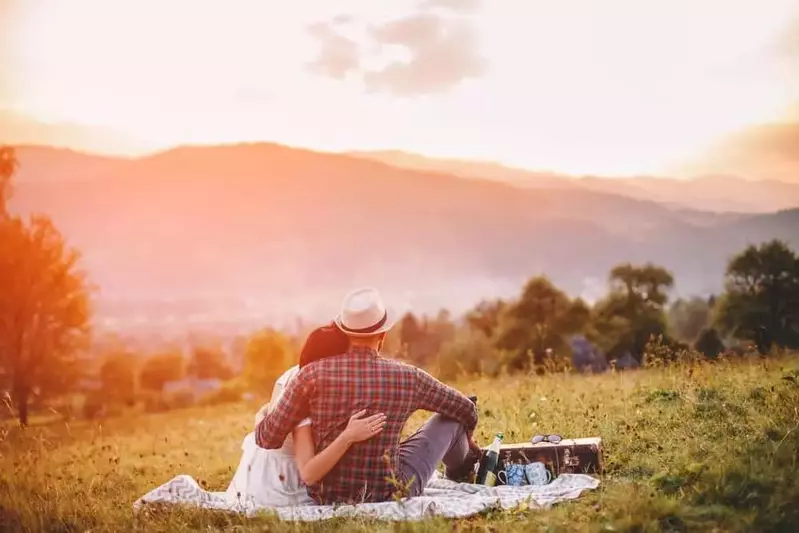 Couple enjoying a picnic in the mountains