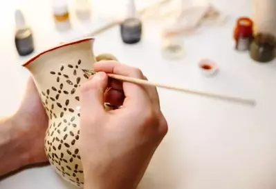 artist painting pottery