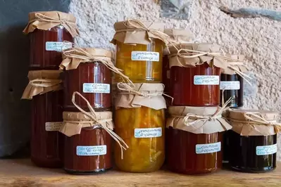 Jars of jam stacked on top of one another.