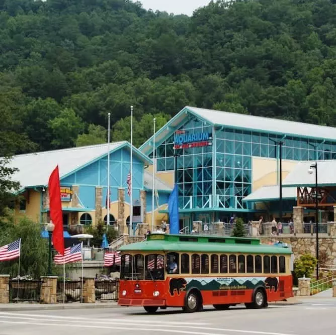 A Gatlinburg trolley parked in front of Ripley's Aquarium of the Smokies.