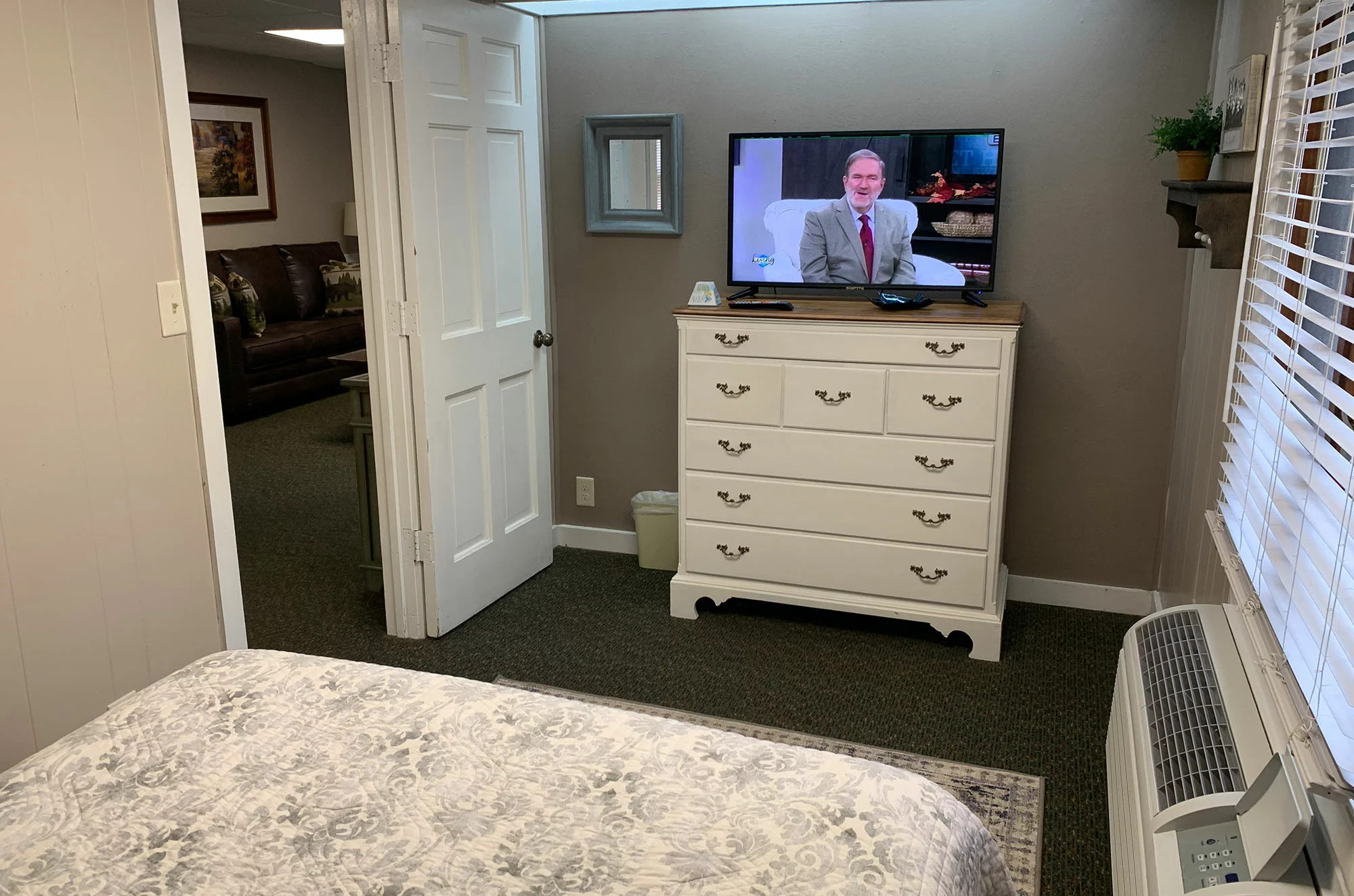 bed facing TV in Maples Cottage